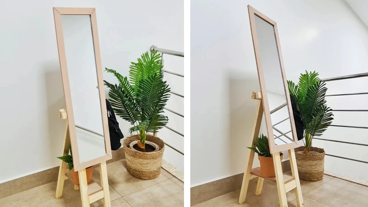 Espelho de corpo inteiro apoiado no cavalete com um vaso pequeno de planta.