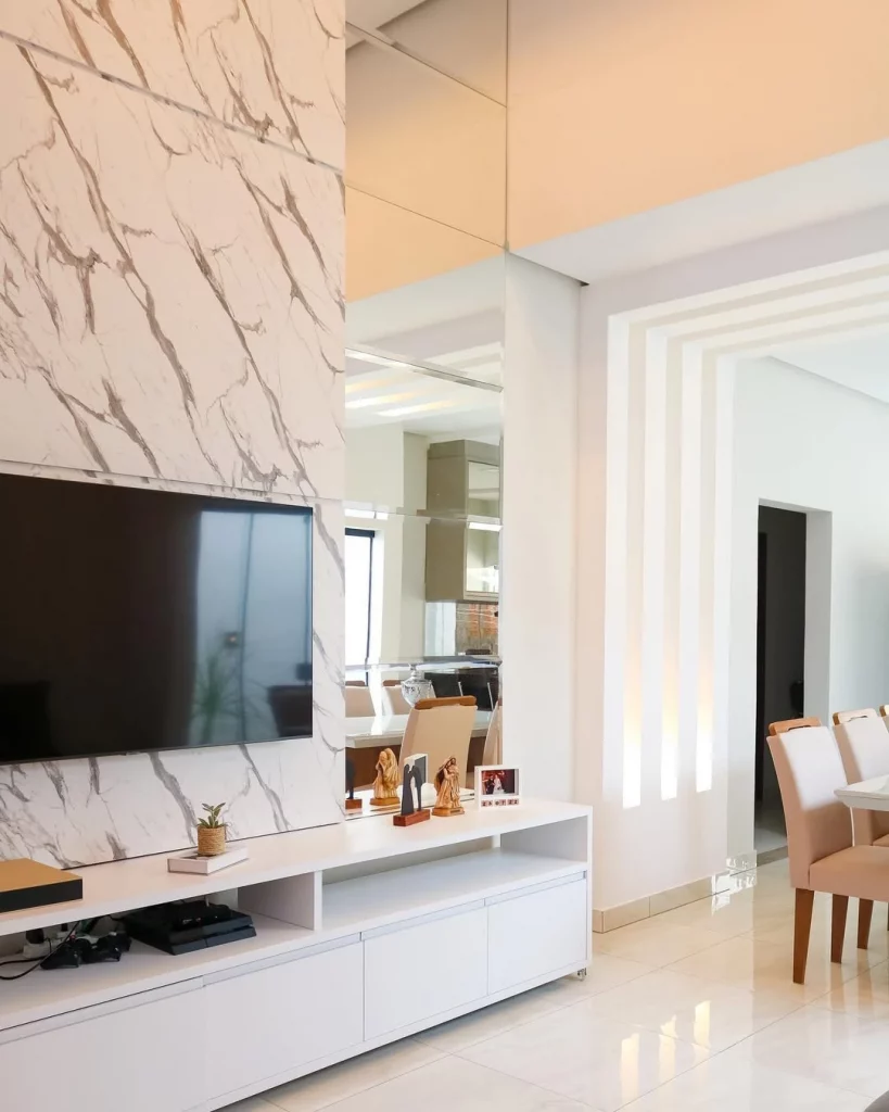 Espelhos enfileirados e quadrados, sem moldura, na sala de estar.