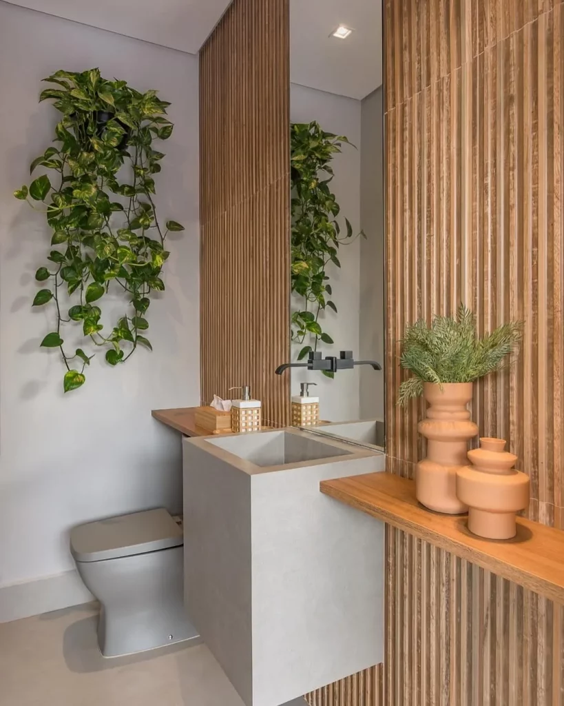 Banheiro com textura de ripado e vasos de barro.