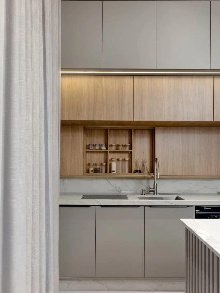 Cozinha séria e moderna com iluminação no armário.