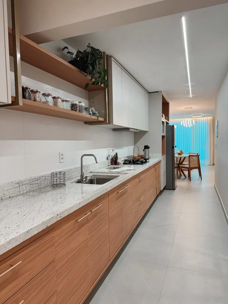 Cozinha com bancada de granito e armário de madeira.