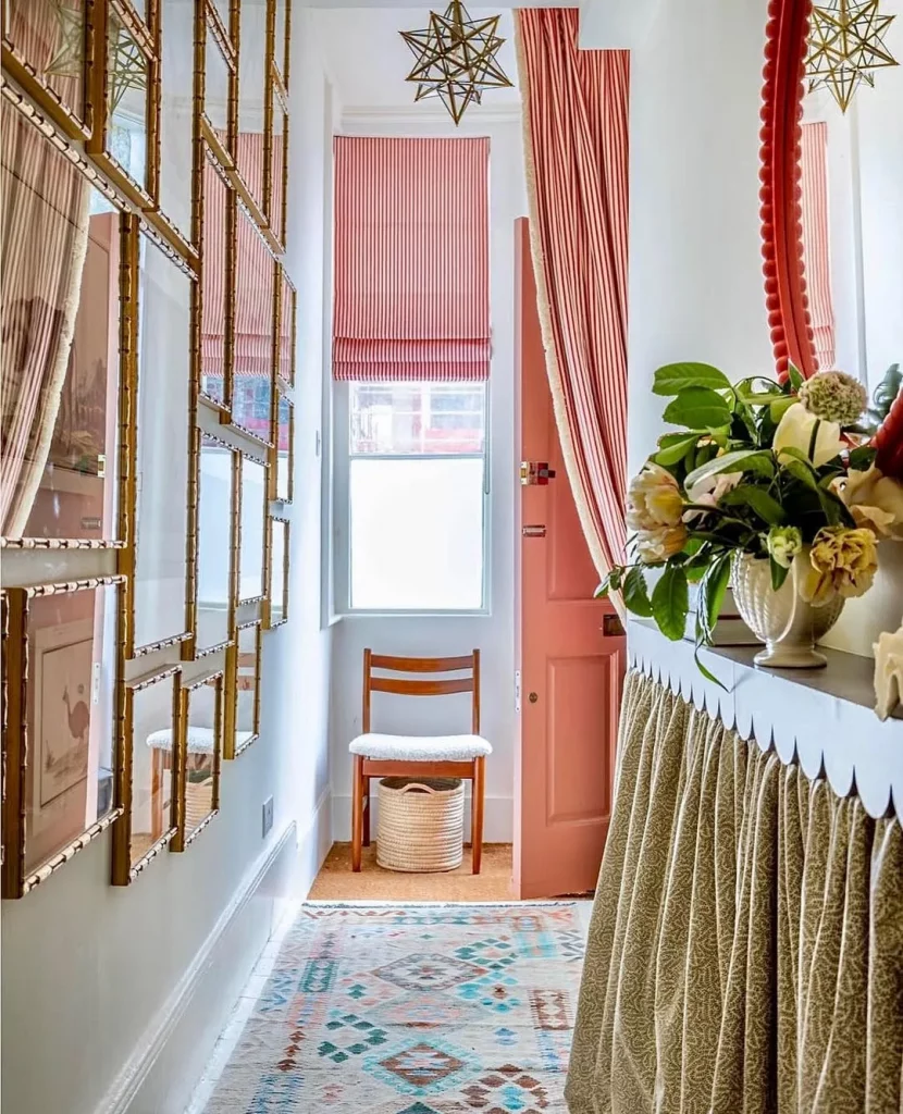 Hall de entrada com muitos detalhes, cortina vermelha xadrez, vaso de plantas.