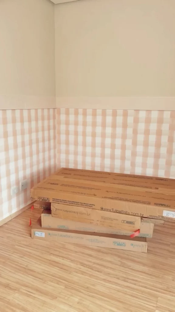 Parede com detalhe xadrez de papel adesivo e caixas.