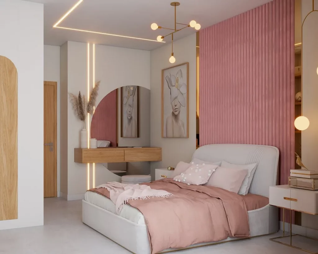 Penteadeira no quarto rosa com luz de led na parede e espelho meia lua.