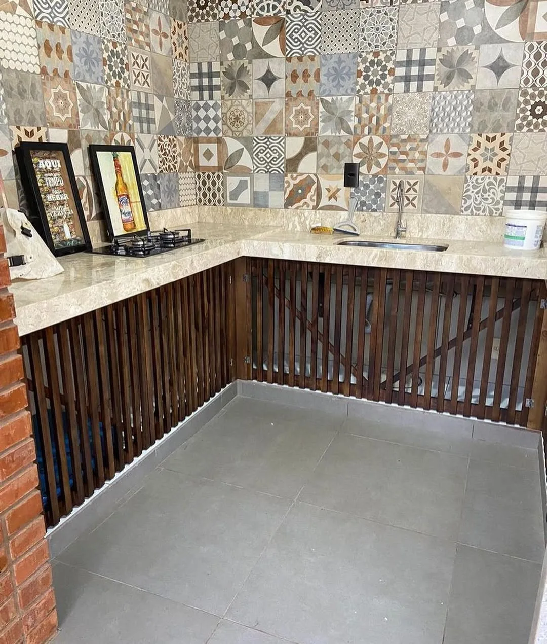 Cozinha da área gourmet com armário improvisado de pallets.