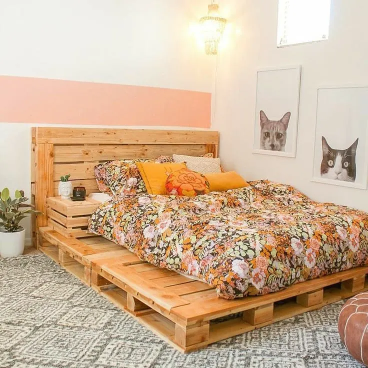 Quarto com faixa de parede rosa, base e cabeceira de pallet.